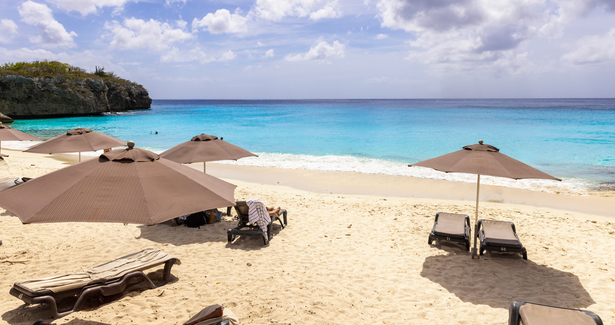 Beach with brown parasols