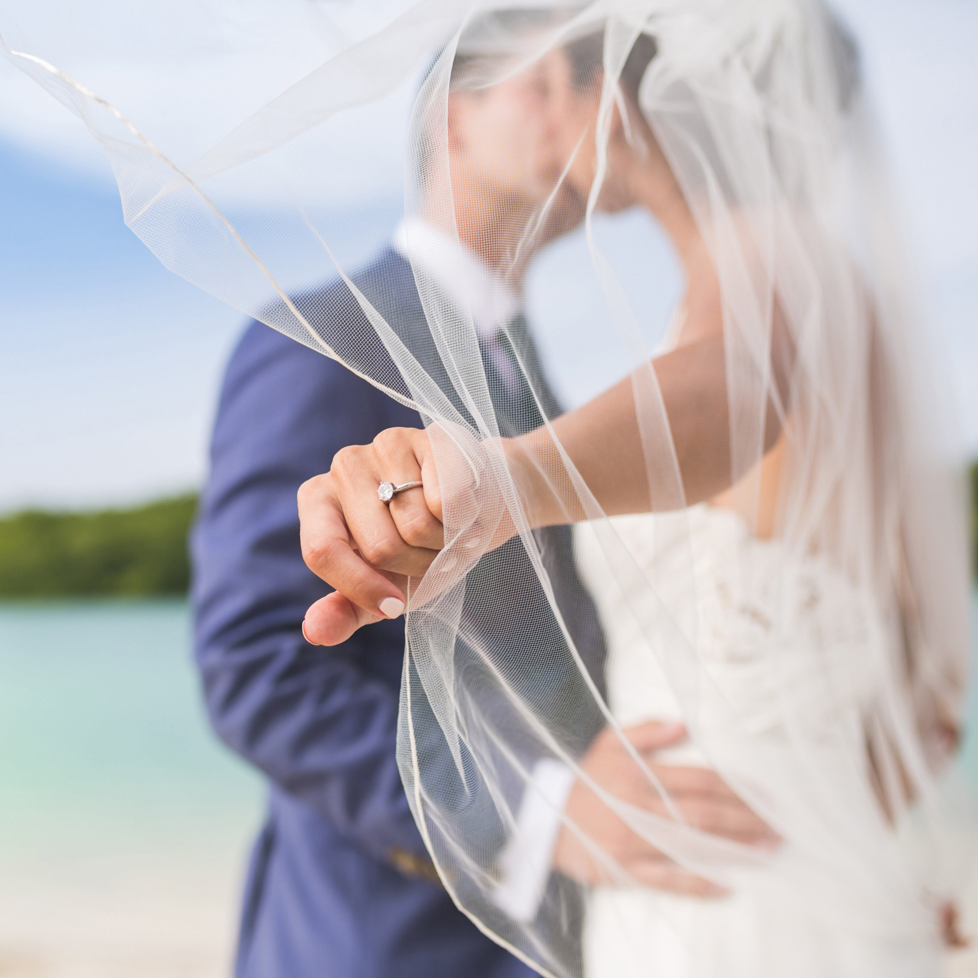 Newlyweds Kissing with Ring