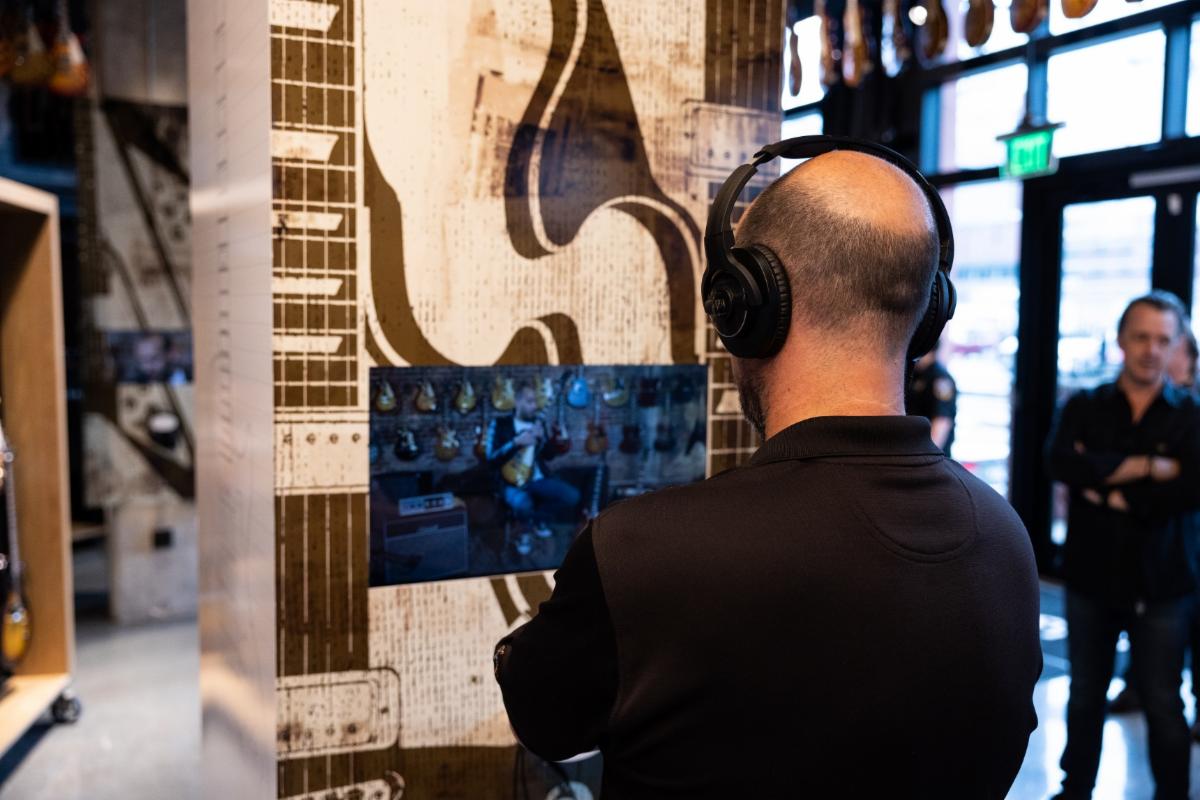 A fan enjoys an interactive, historical installation at the Gibson Garage.