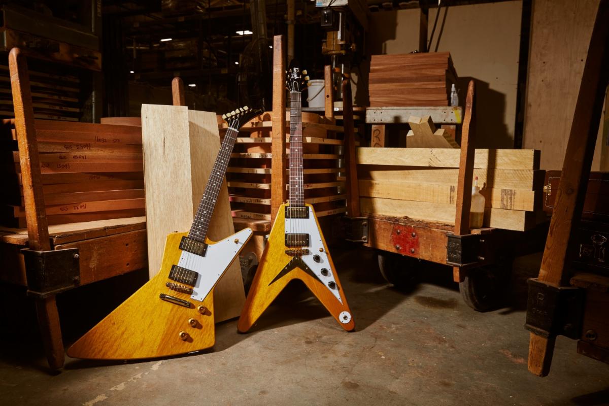 (L-R): the Gibson 1958 Korina Explorer and Flying V Reissue with White pickguard.