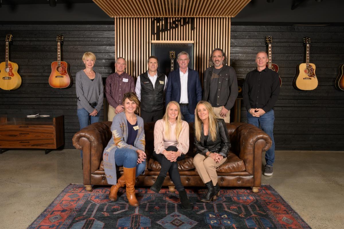 Gibson leadership and Montana Ambassadors Association. (back row L-R) Anne Rohosy (Chief Human Resources and Impact Officer, Gibson Brands), and Montana Ambassadors Brian Arthur, Tyler Delaney, and James Thompson, James “JC” Curleigh (President and CEO, Gibson Brands) and Jeremy Freckleton (Chief Production Officer, Gibson Brands), (front row L-R) Montana Ambassadors Jami Lorenz, Suzi Berget White, and Angela Mcgrath.