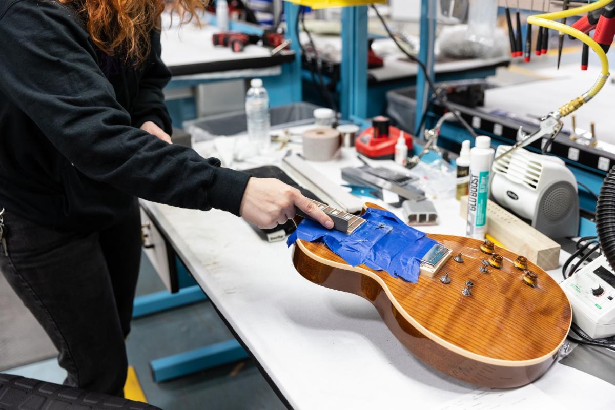 A Gibson R&R Tech repairs a Gibson Les Paul.