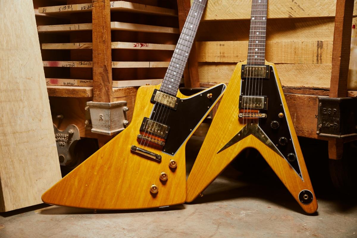 (L-R): the Gibson 1958 Korina Explorer and Flying V Reissue with Black pickguard.