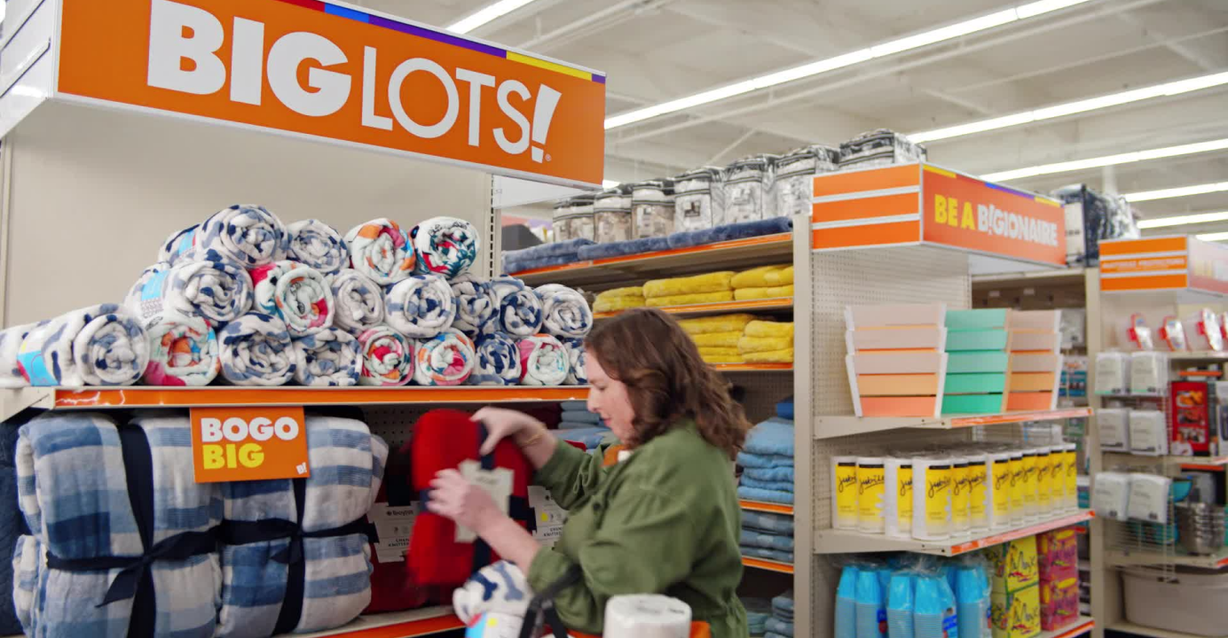 Big Lots! 'Be a BIGionaire' campaign still of a woman shopping for a blanket