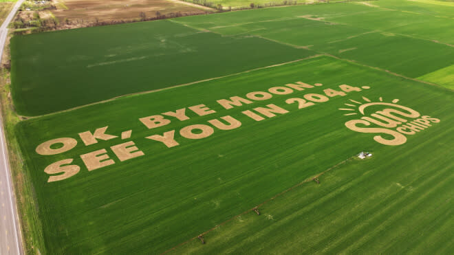 Writing etched into a field that says ok, bye moon, see you in 2044