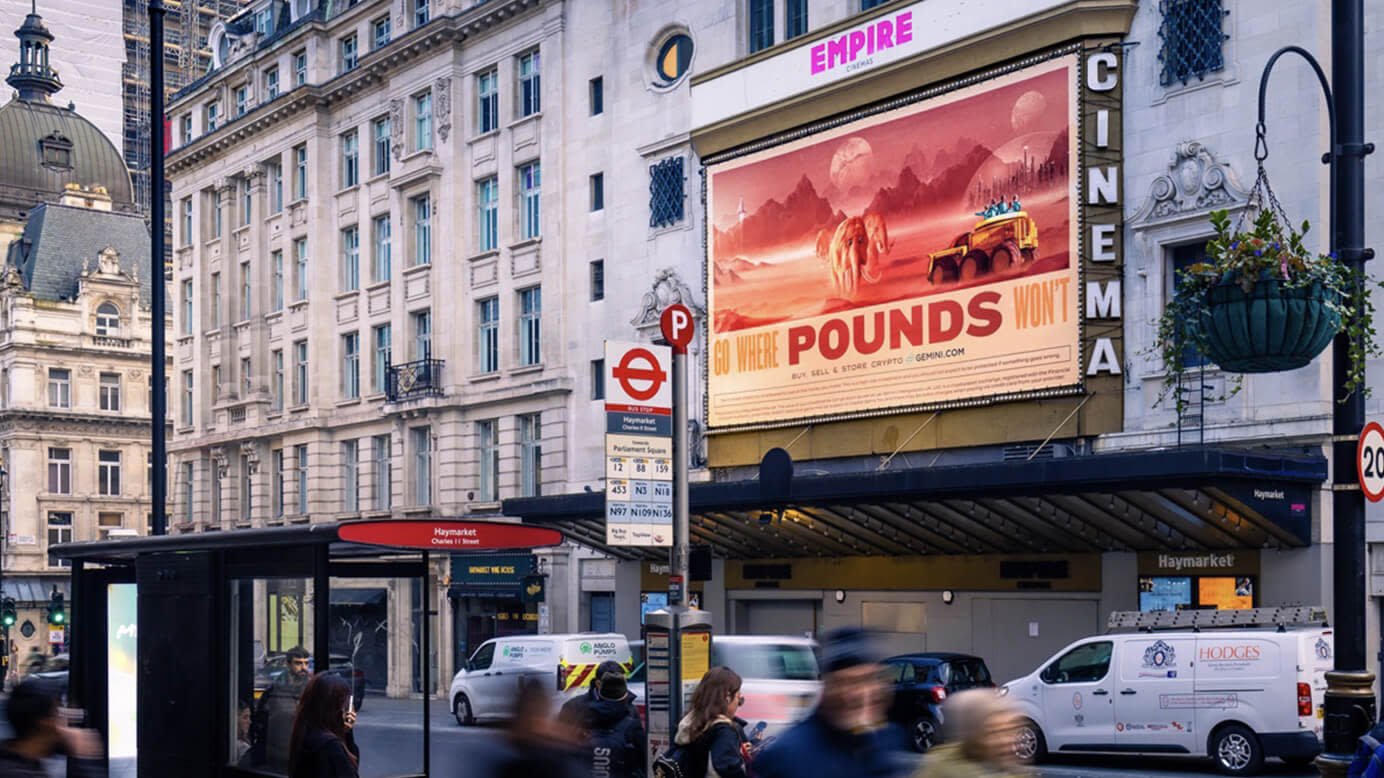 A Go Where Pounds Won't billboard above a cinema on a busy street