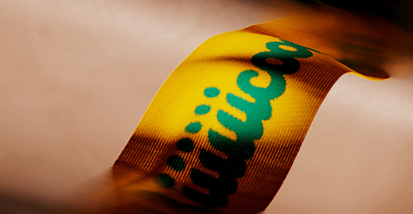 Man wearing a Ricola scarf in a green suit