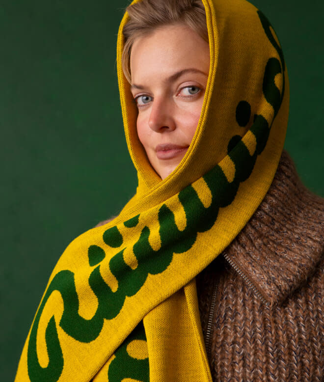 Headshot of a woman wearing the Ricola scarf to cover her ears