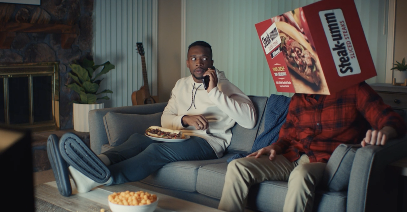 Steak-Umm - "Umm..." campaign still of a guy sitting on the couch watching tv