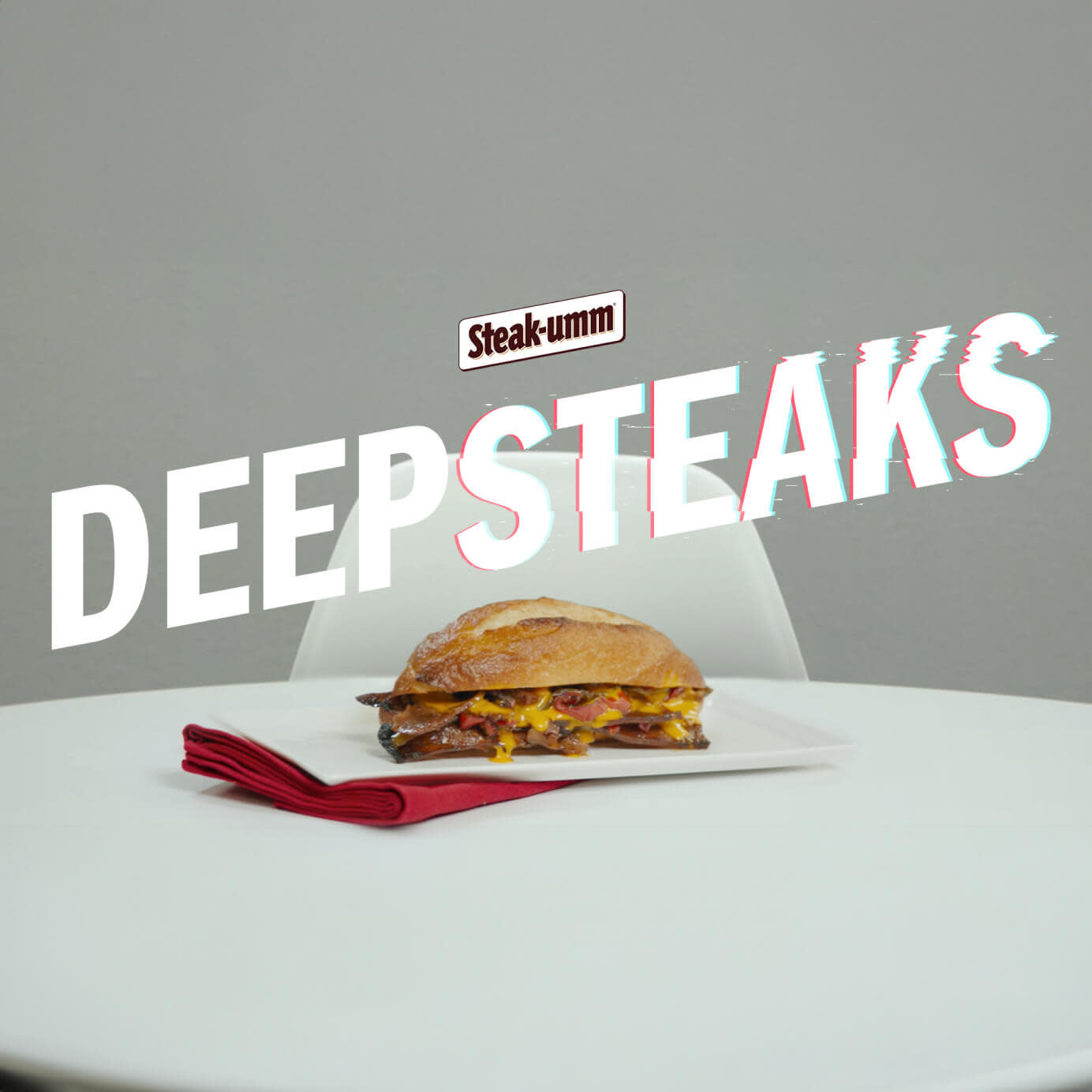 A Steak-umm sandwich sitting on a table with 'Deep Steak' written behind it