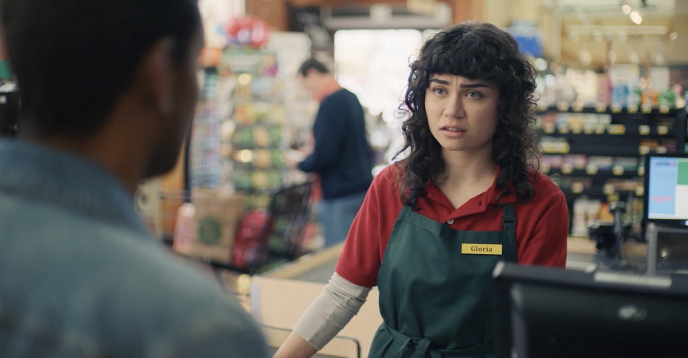 Still shot from the Steak-umm 'Umm...' video campaign | Woman working at a checkout counter