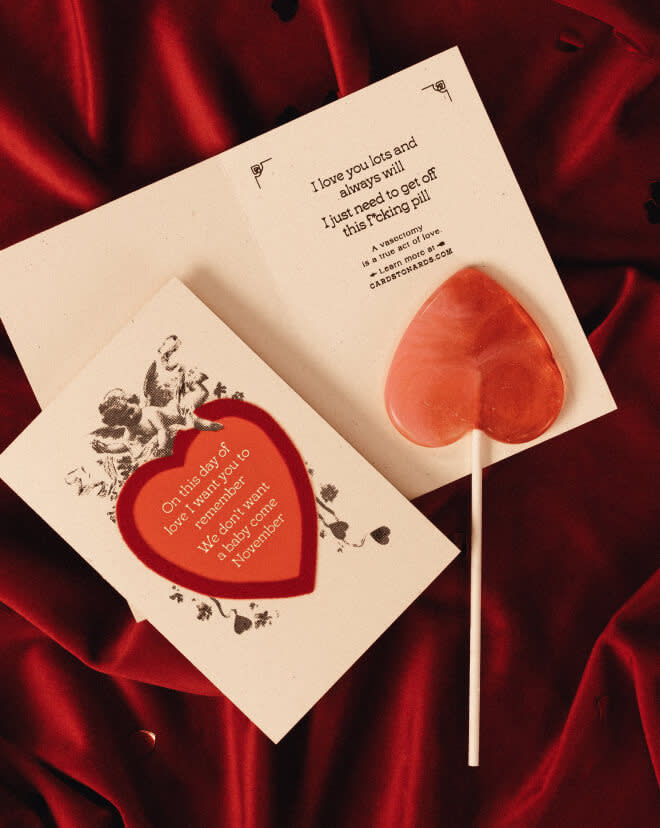 Heart lollipops sitting next to cards