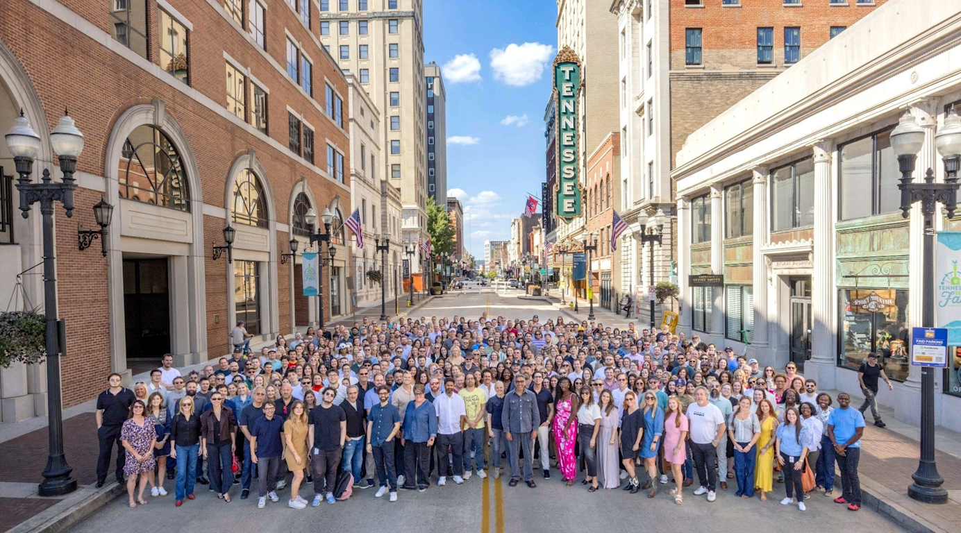 Employees of Tombras standing in Gay St with the Tennessee Theatre sign in the background