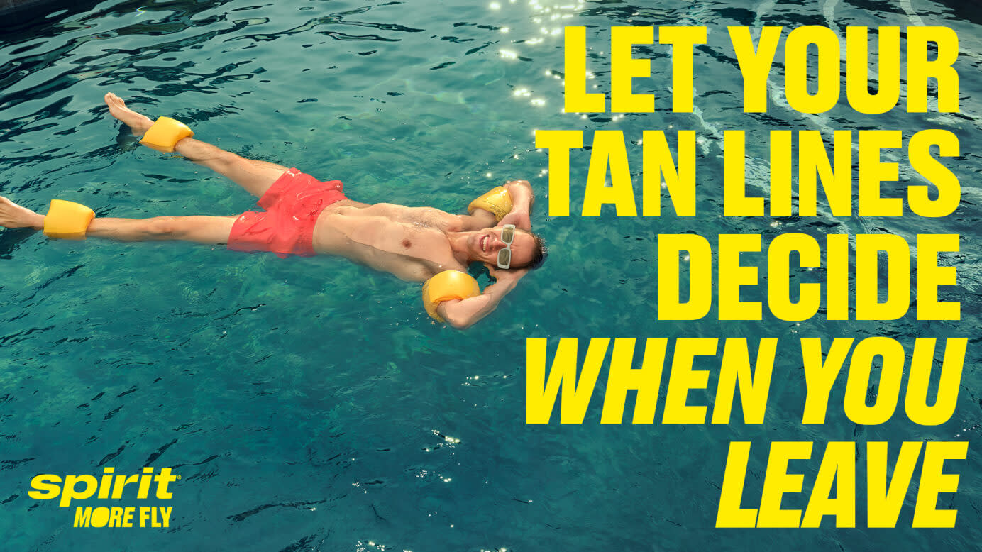 A man swimming in crystal clear blue water with text saying let your tan lines decide when you leave