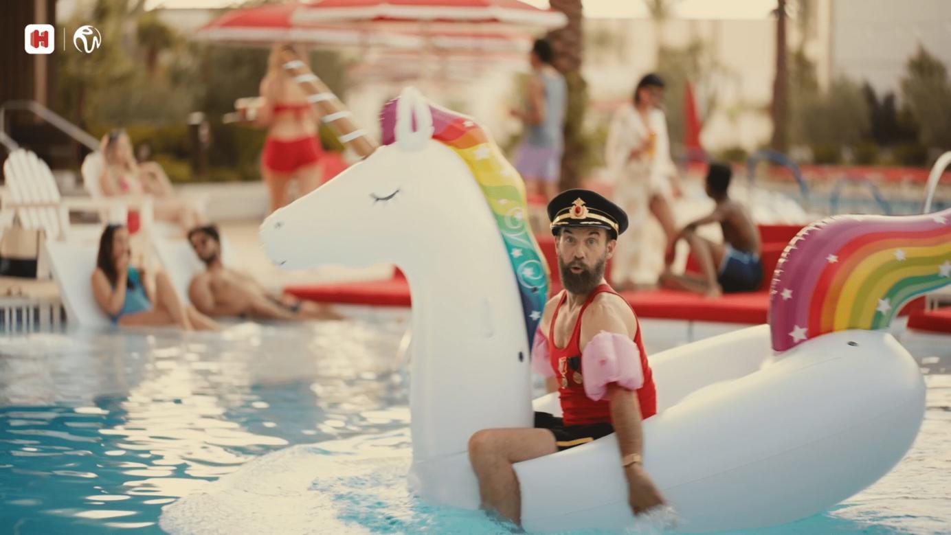 Captain Obvious floating on a unicorn float in a hotel pool