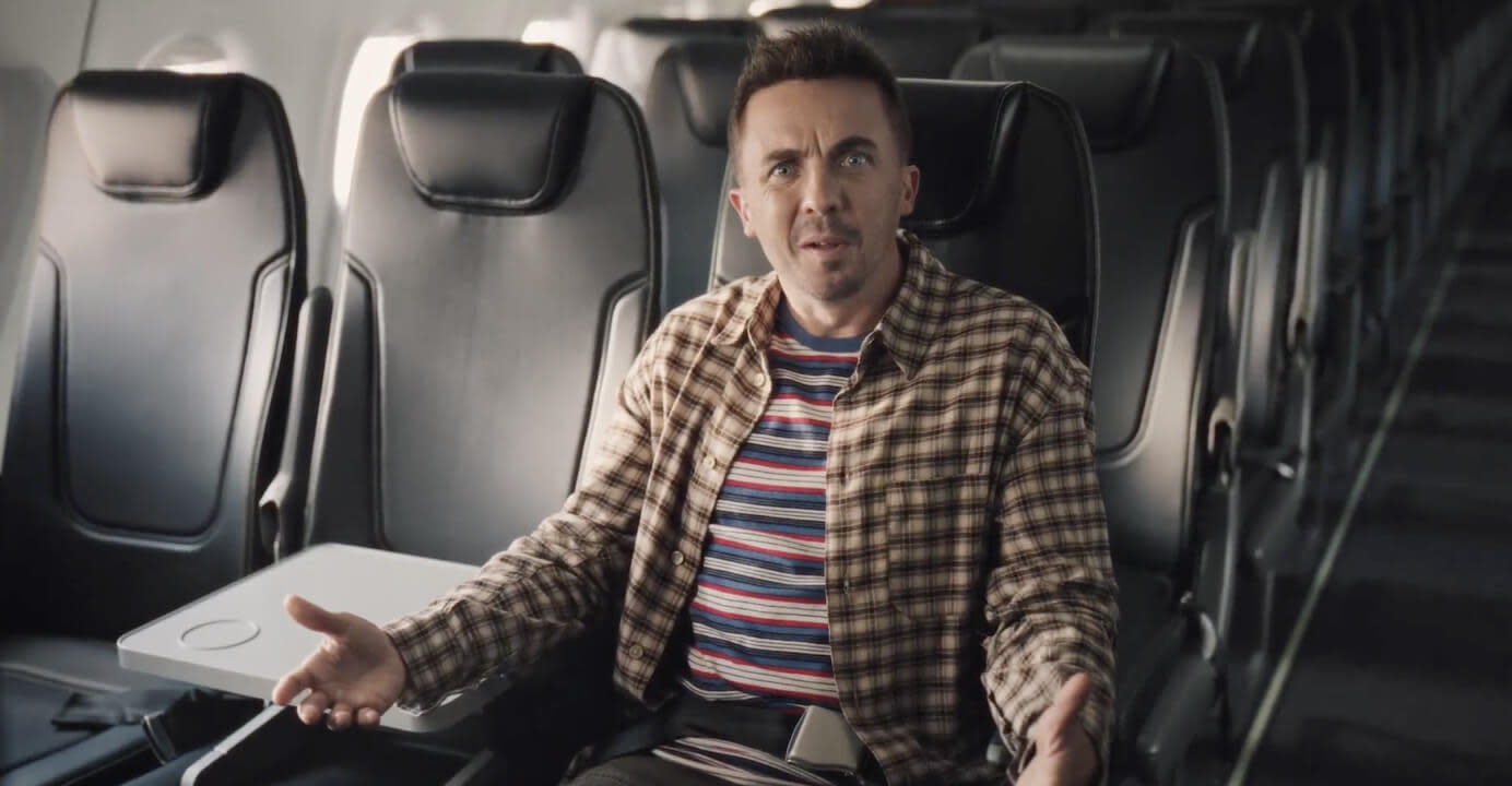 Frankie Muniz sitting in a comfortable airplane seat