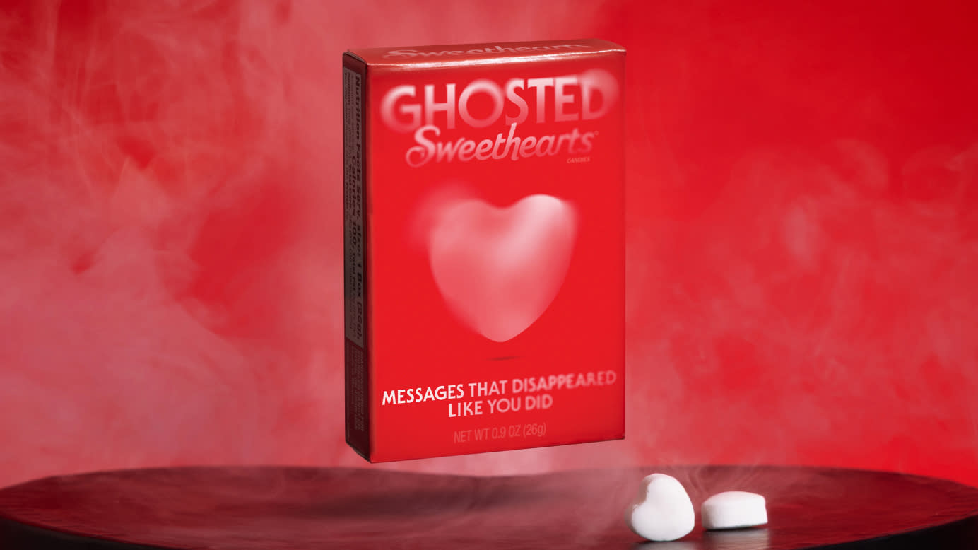 A box of Ghosted Sweethearts eerily floating over a pedestal with two white hearts next to it