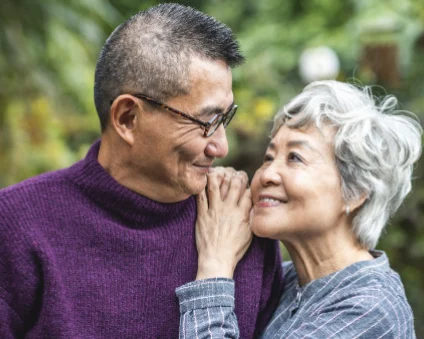 Aspen Dental patients smiling at one another.