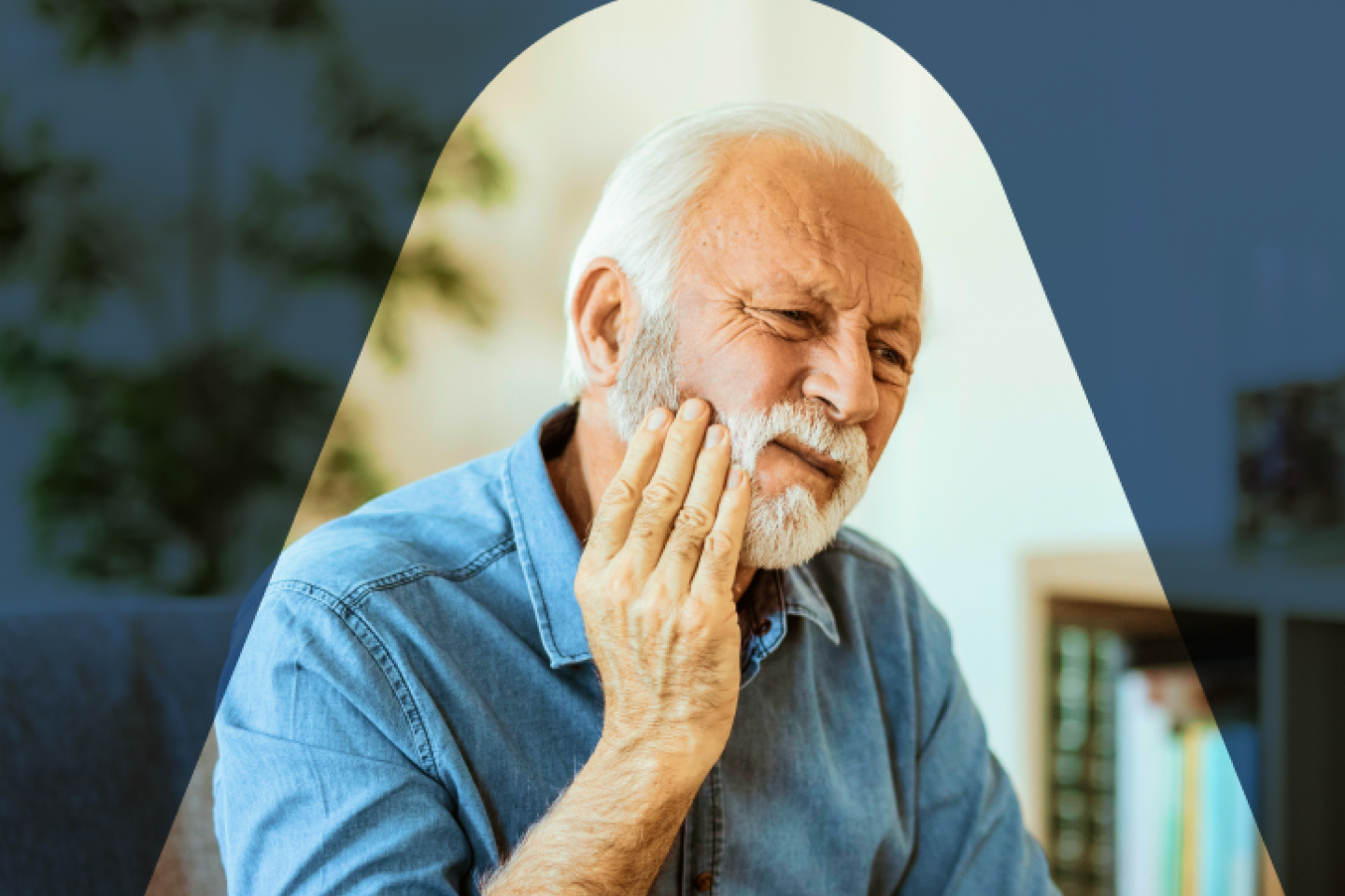 A man with a distressed expression, hand pressed to his cheek, wincing in apparent tooth pain, or other oral discomfort.