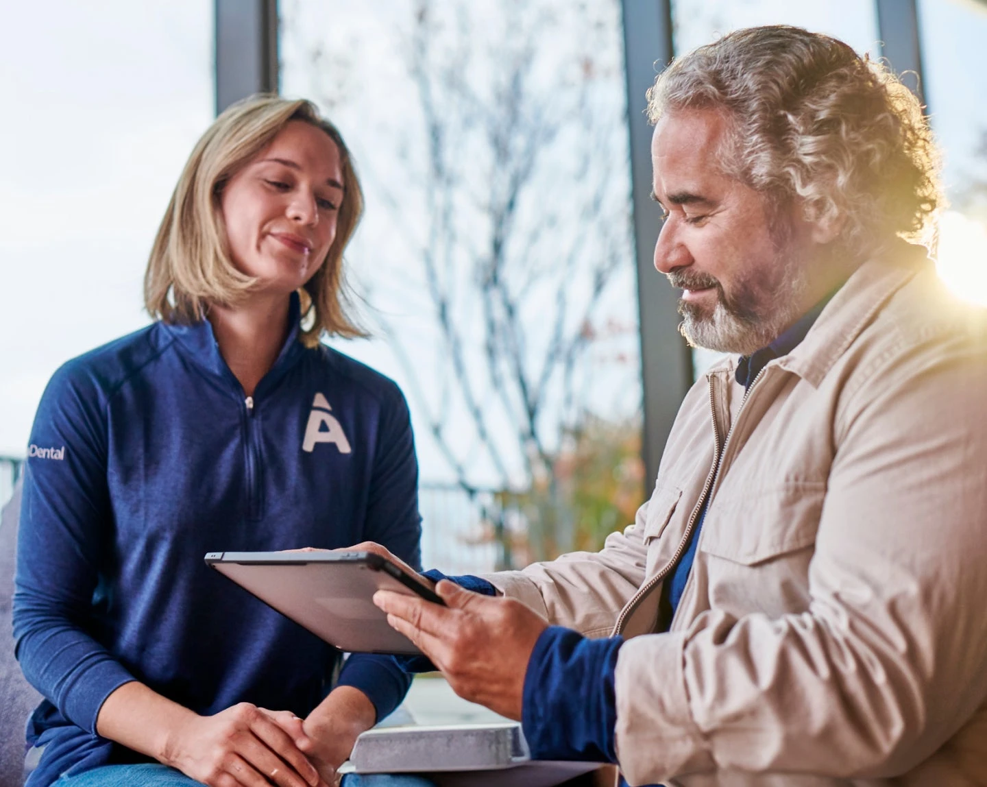 An Aspen Dental professional discussing partial dentures cost with a patient, providing customized and affordable tooth replacement options.
