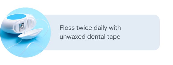 A spool of unwaxed dental tape with the floss partially extended, shown on a light blue background. The accompanying text advises flossing twice daily using unwaxed dental tape for optimal oral hygiene.