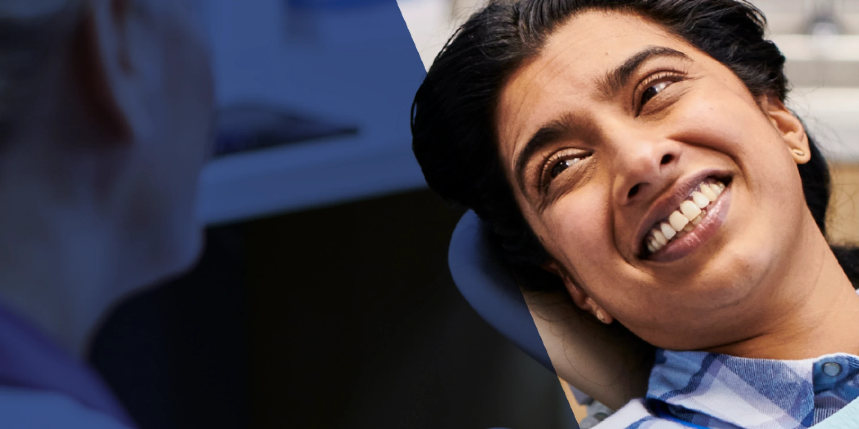 An Aspen Dental patient smiles in a dental chair. 