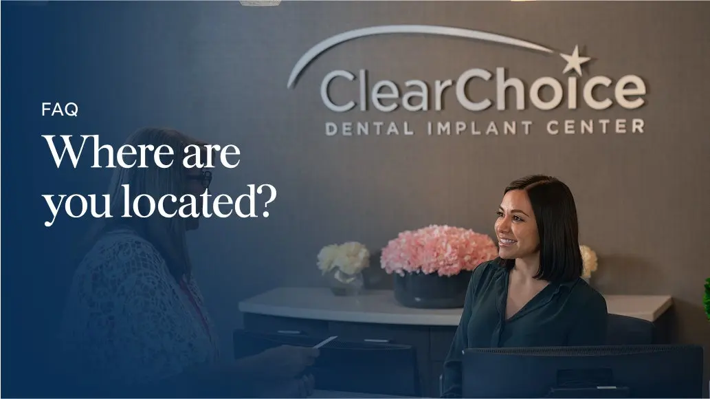 A friendly ClearChoice receptionist welcoming a patient at the front desk of a ClearChoice Dental Implant Center, highlighting the clinic's inviting atmosphere.