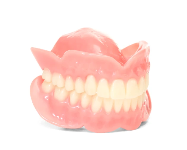 Naturalytes full dentures with a complete set of white teeth, pink gums, on white background.