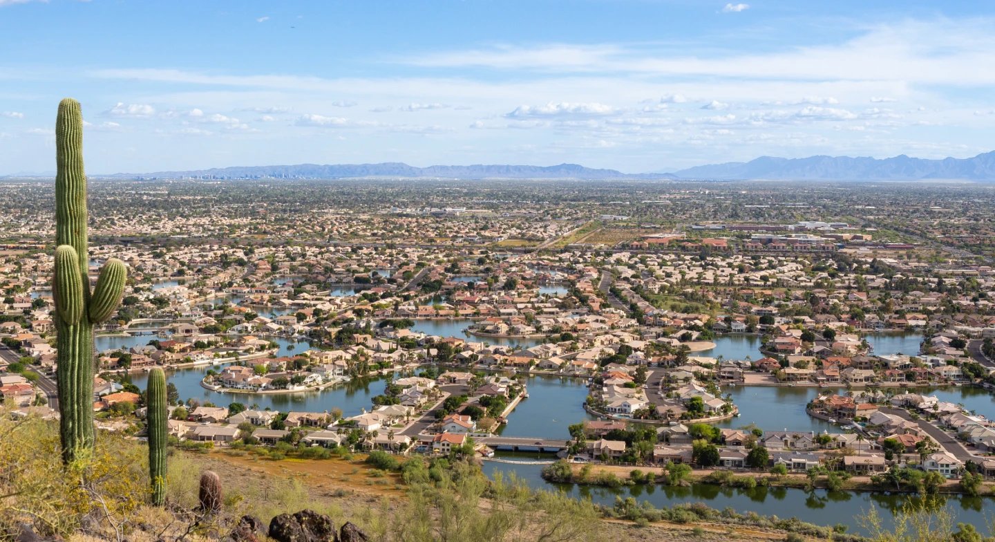 A view of a neighborhood in Phoenix, AZ from a mountain at midday