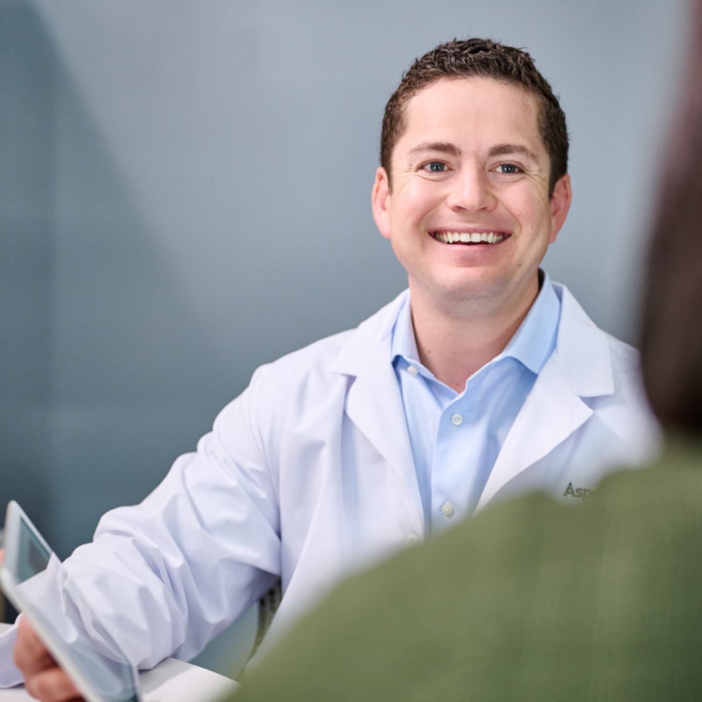An Aspen Dental doctor smiles. 