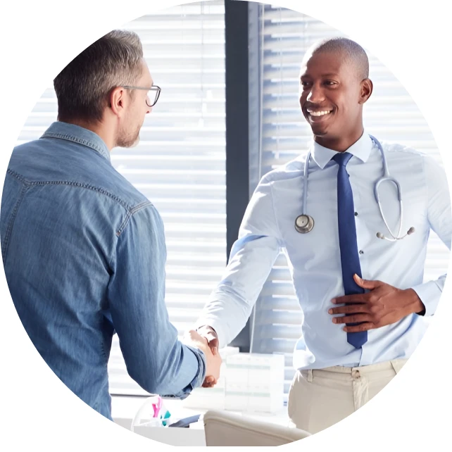 A WellNow doctor shakes hands with a patient. 