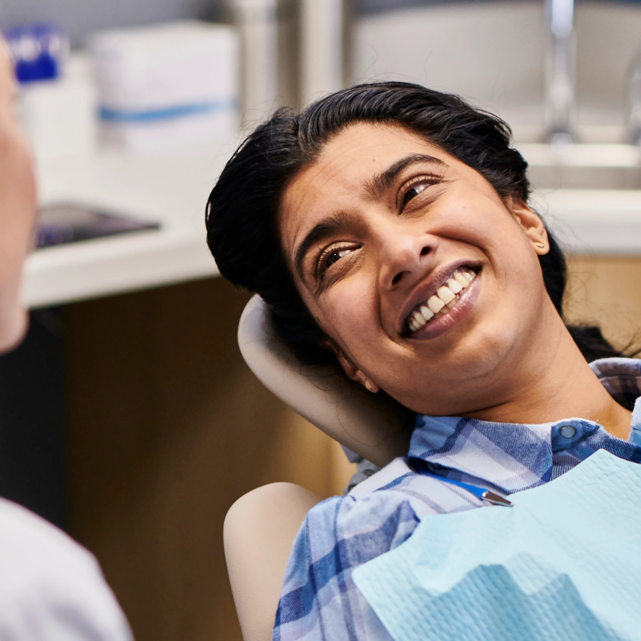 An Aspen Dental veneers patient smiles. 