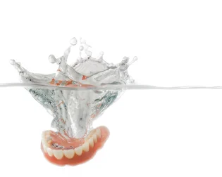 Dentures are dropped underwater. 
