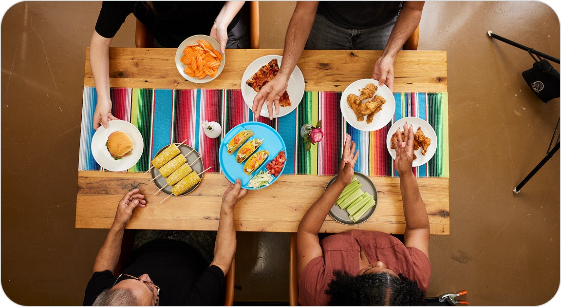 Patients gathering with their family and friends to enjoy some of their favorite foods again after receiving their dental implants and restoring full eating function.