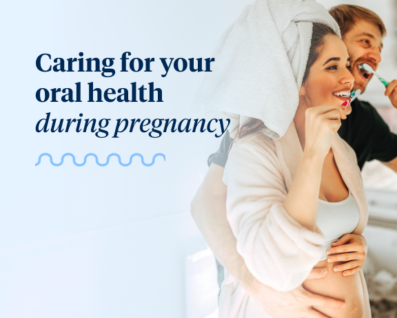 Pregnant woman with a towel on her head brushing her teeth and smiling, standing next to man who is also brushing his teeth, with text above saying "Caring for your oral health during pregnancy".
