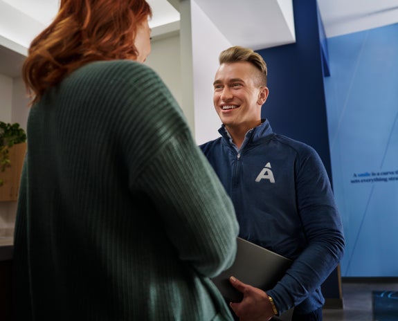 Aspen Dental professional discussing wisdom teeth with a patient in a welcoming clinic setting.