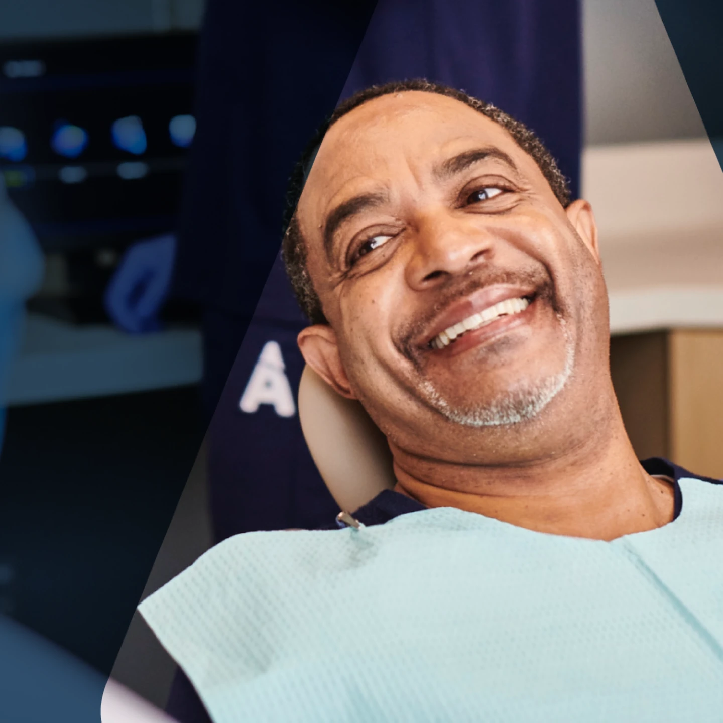 A man smiles in an Aspen Dental office. 