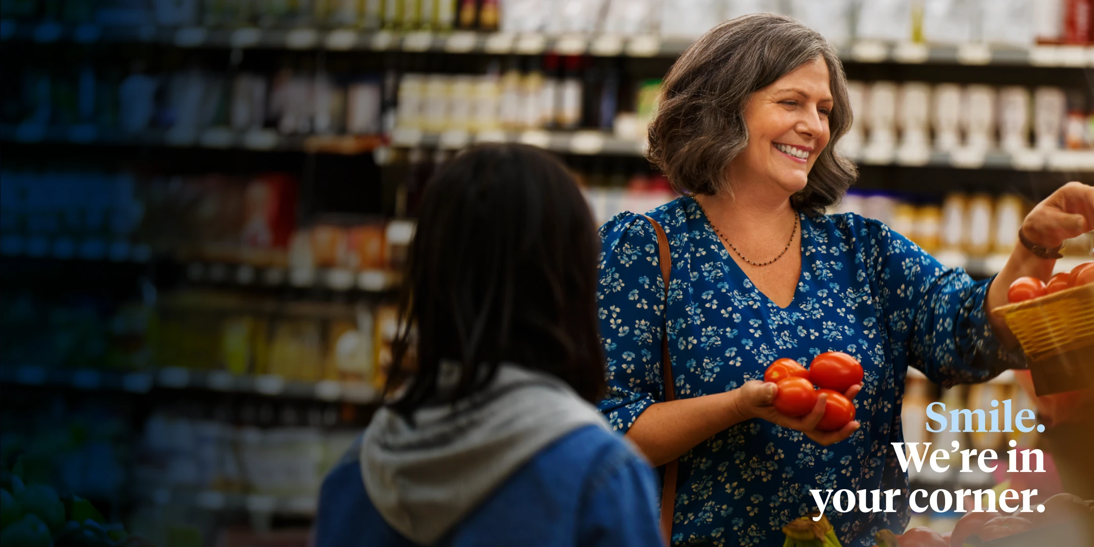 An Aspen Dental implants patient shops for produce in the grocery store. 