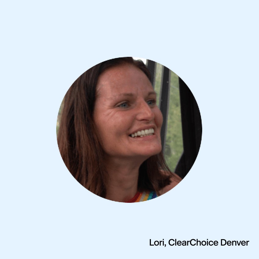 A woman with dark hair smiling.