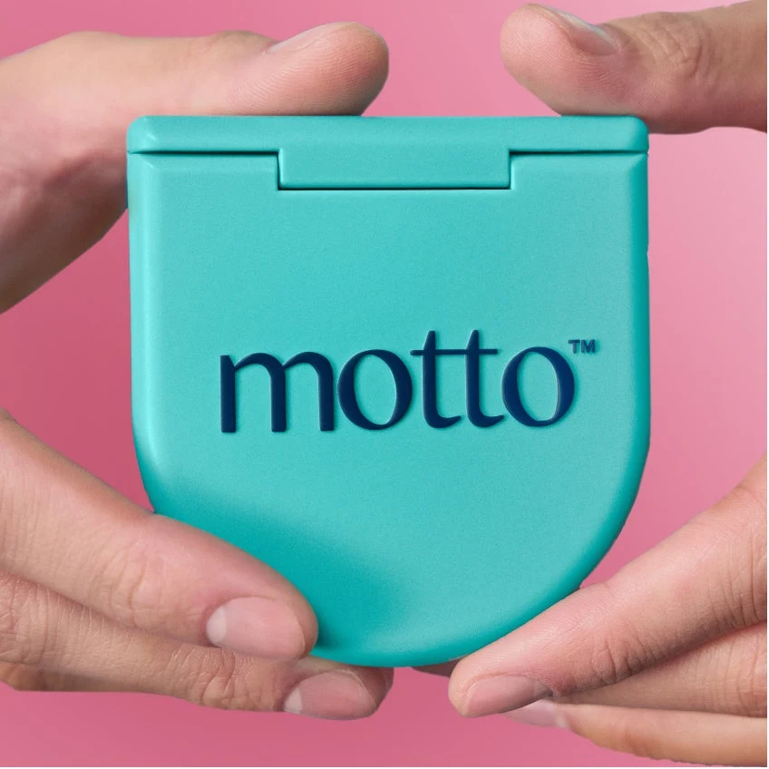 Hands hold a closed Motto clear aligners case.