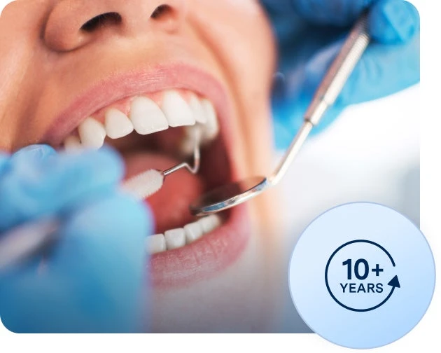 A dental professional in blue gloves examines a patient's teeth with dental tools. A circular badge at the bottom right states "10+ Years.