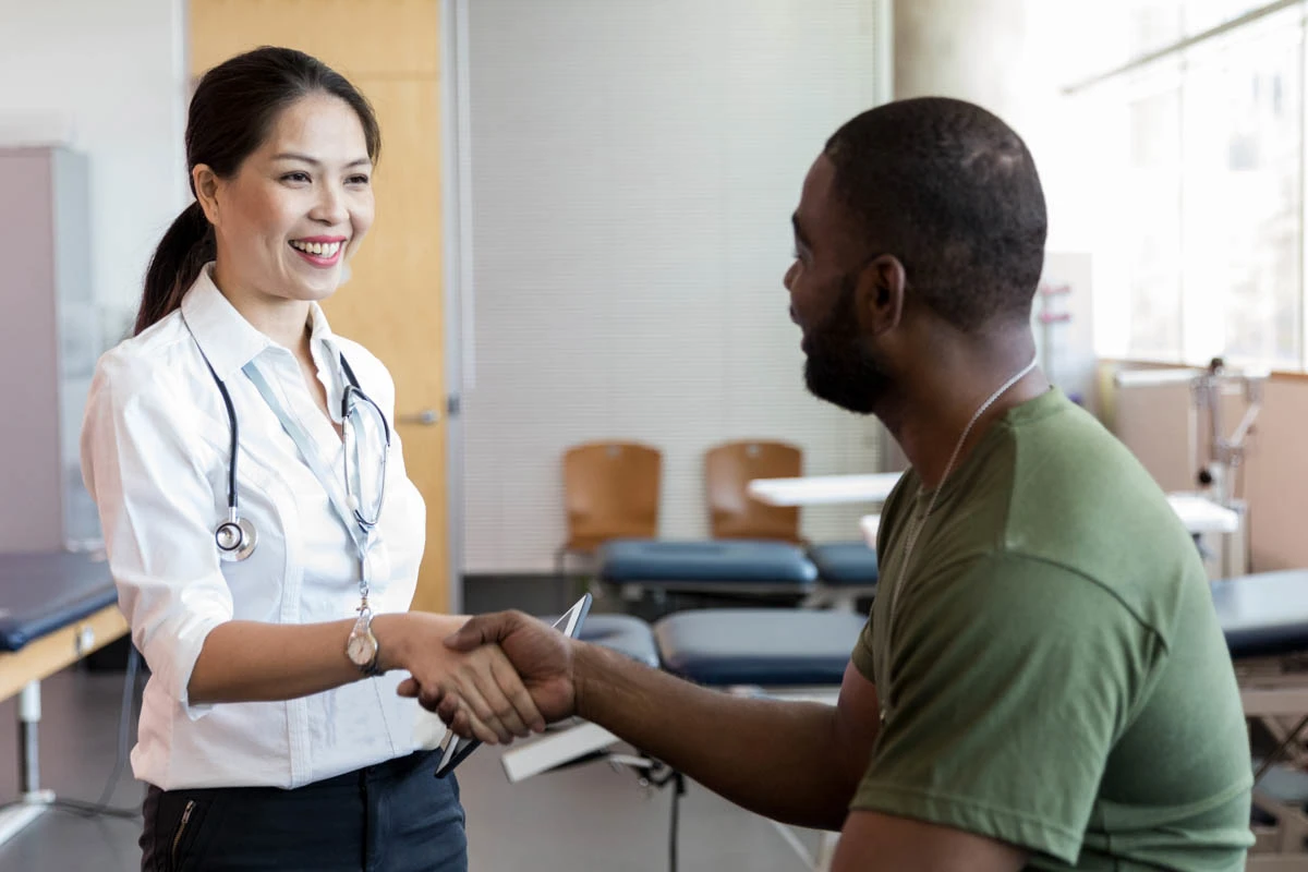 A WellNow doctor shakes hands with a patient. 