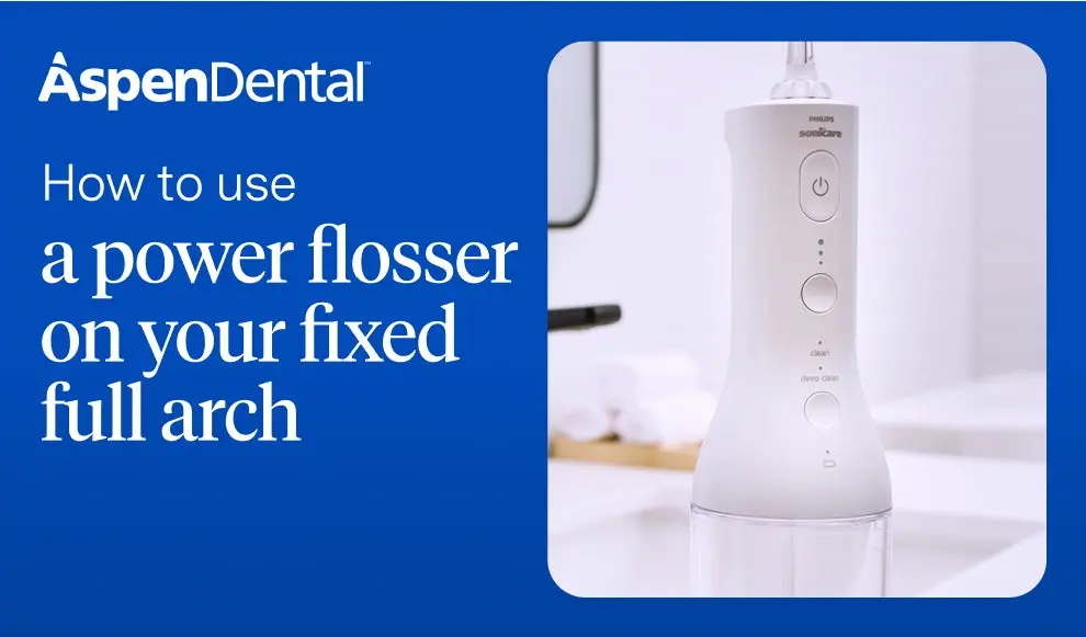 Dental provider introducing how to use a power flosser on fixed full arch dental implants.