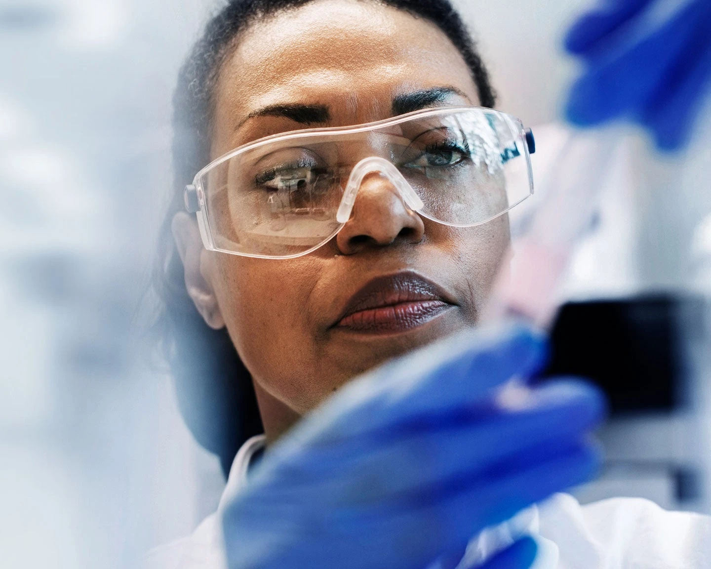A close up of a lab technician testing medical samples from a patient.