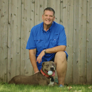 A photo of Aspen Dental patient, Garry, with his dog. 