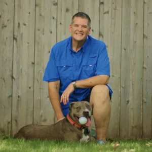A photo of Aspen Dental patient, Garry, with his dog. 
