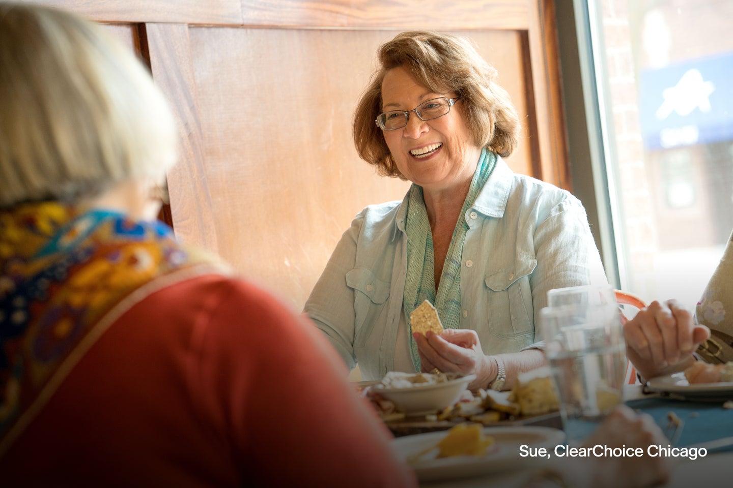 An image of Sue, a ClearChoice patient from Chicago, eating with her improved self-esteem.