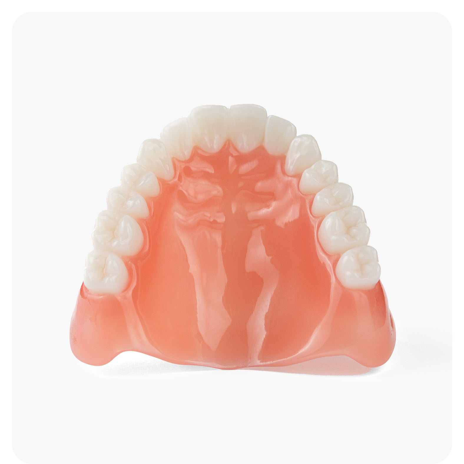 A close-up image of an upper denture model displayed against a white background, highlighting denture structure and design for Aspen Dental.