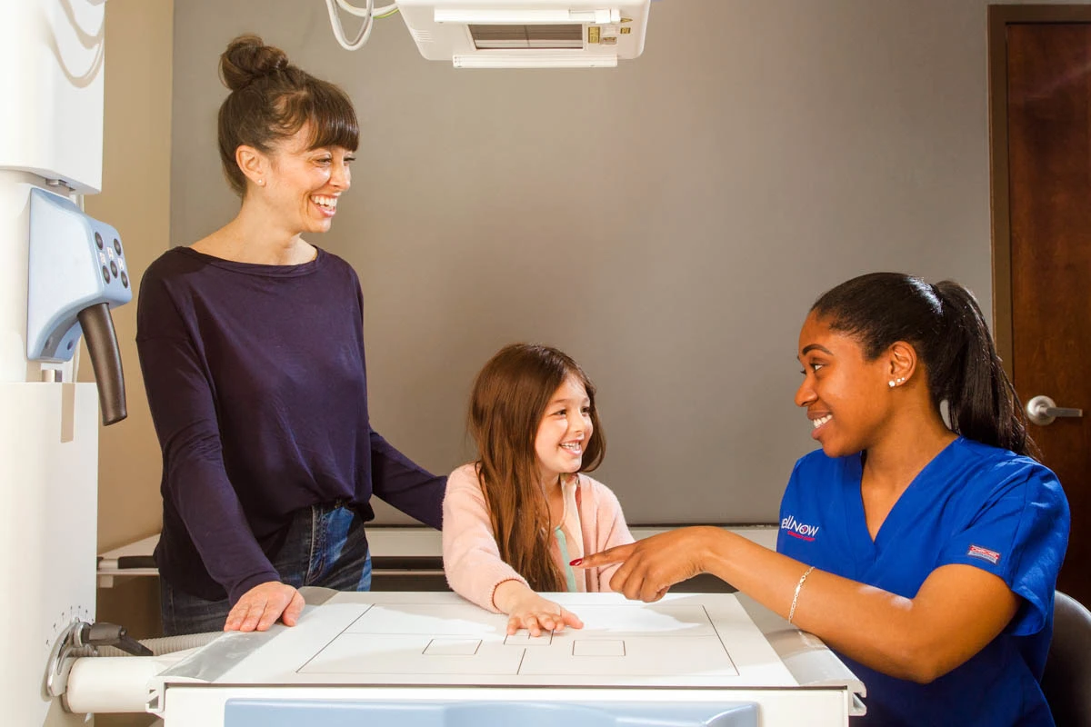 A WellNow doctor consults with a girl and her mother.
