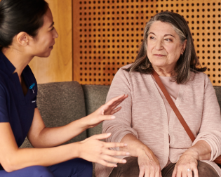An Aspen Dental doctor consults with a patient. 